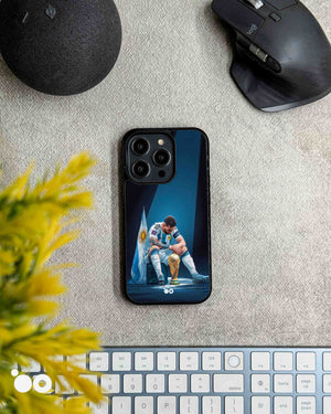 Lionel Messi After Glory iPhone case featuring Messi seated beside the World Cup trophy with Argentina flag and blue spotlight