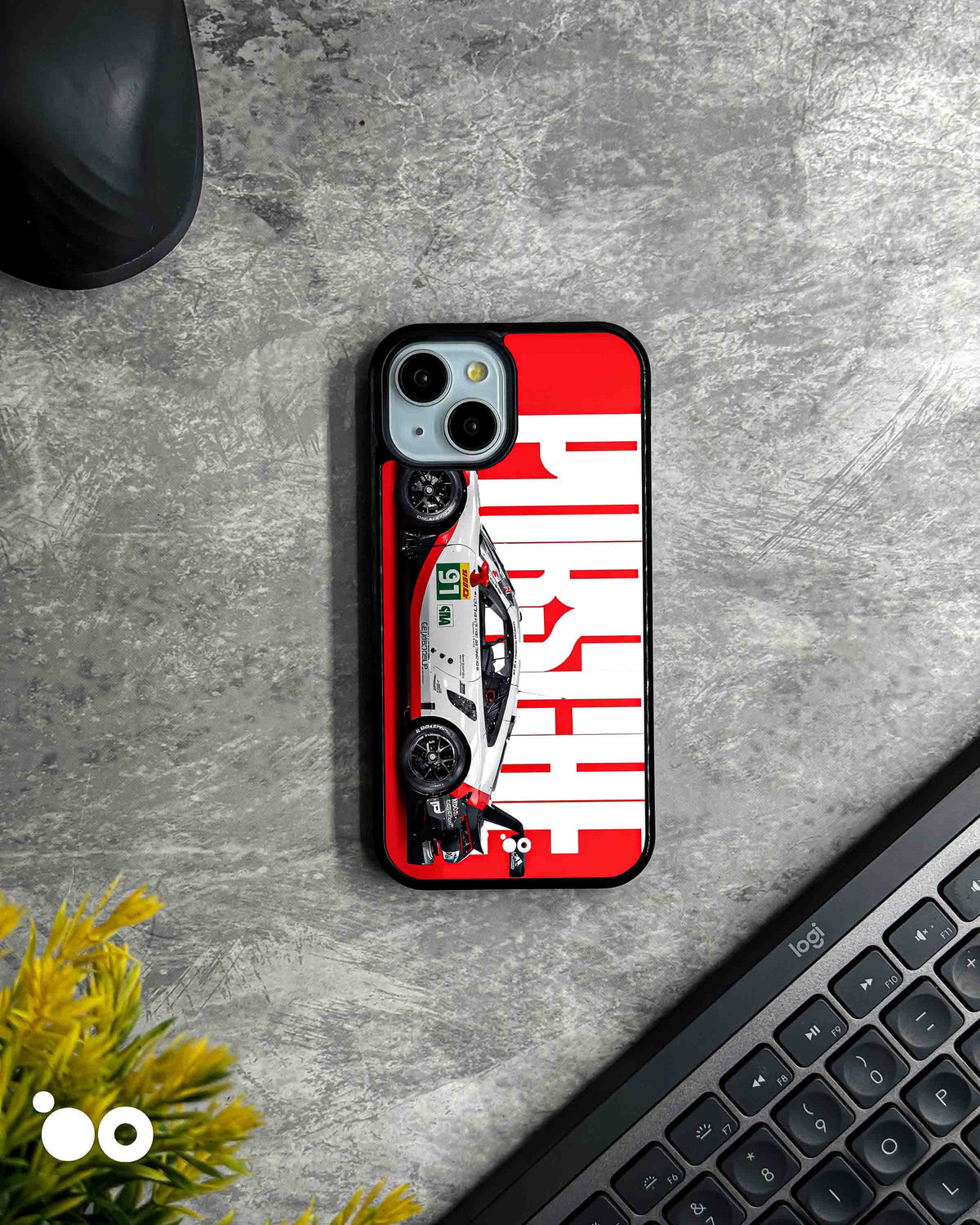 Porsche Racing Heritage iPhone case featuring a white Porsche race car with red and black detailing, bold oversized Porsche typography and a striking red and white motorsport background.