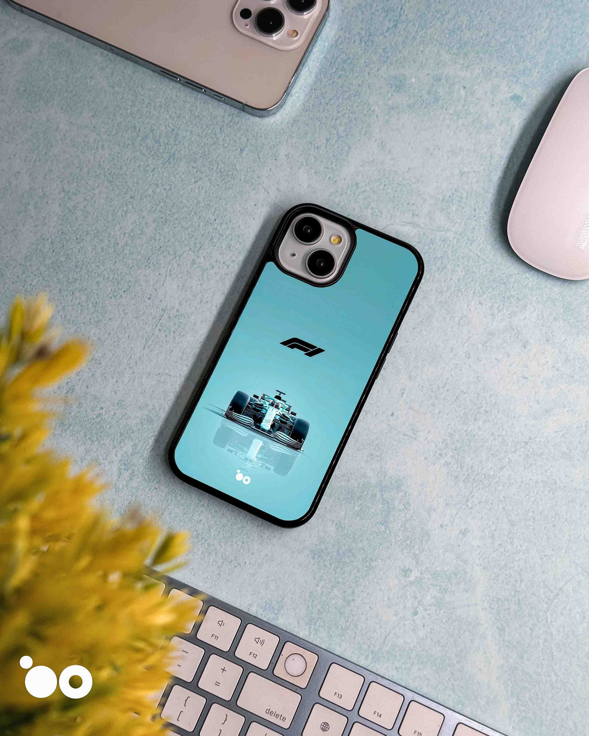 Silver Arrow Mercedes-AMG iPhone case featuring a front-facing Formula 1 racing car, F1 logo and turquoise gradient
