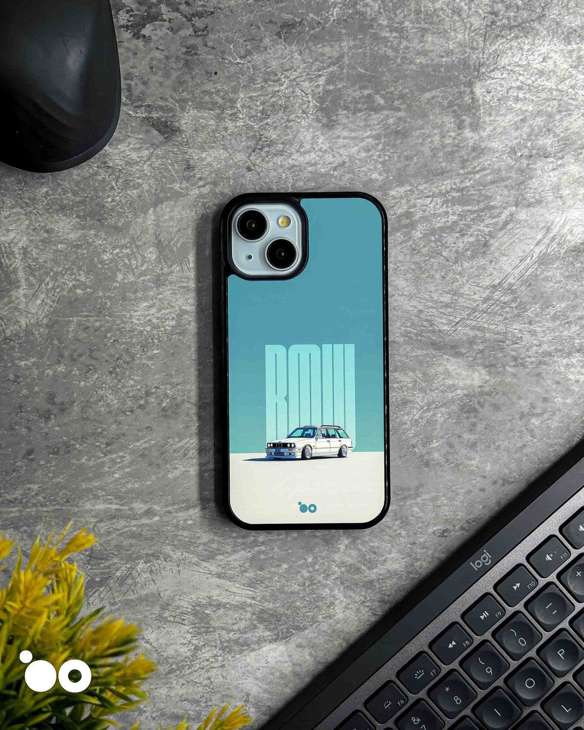 BMW E30 Touring designer iPhone case featuring a classic white BMW E30 station wagon with bold BMW typography on a teal background.