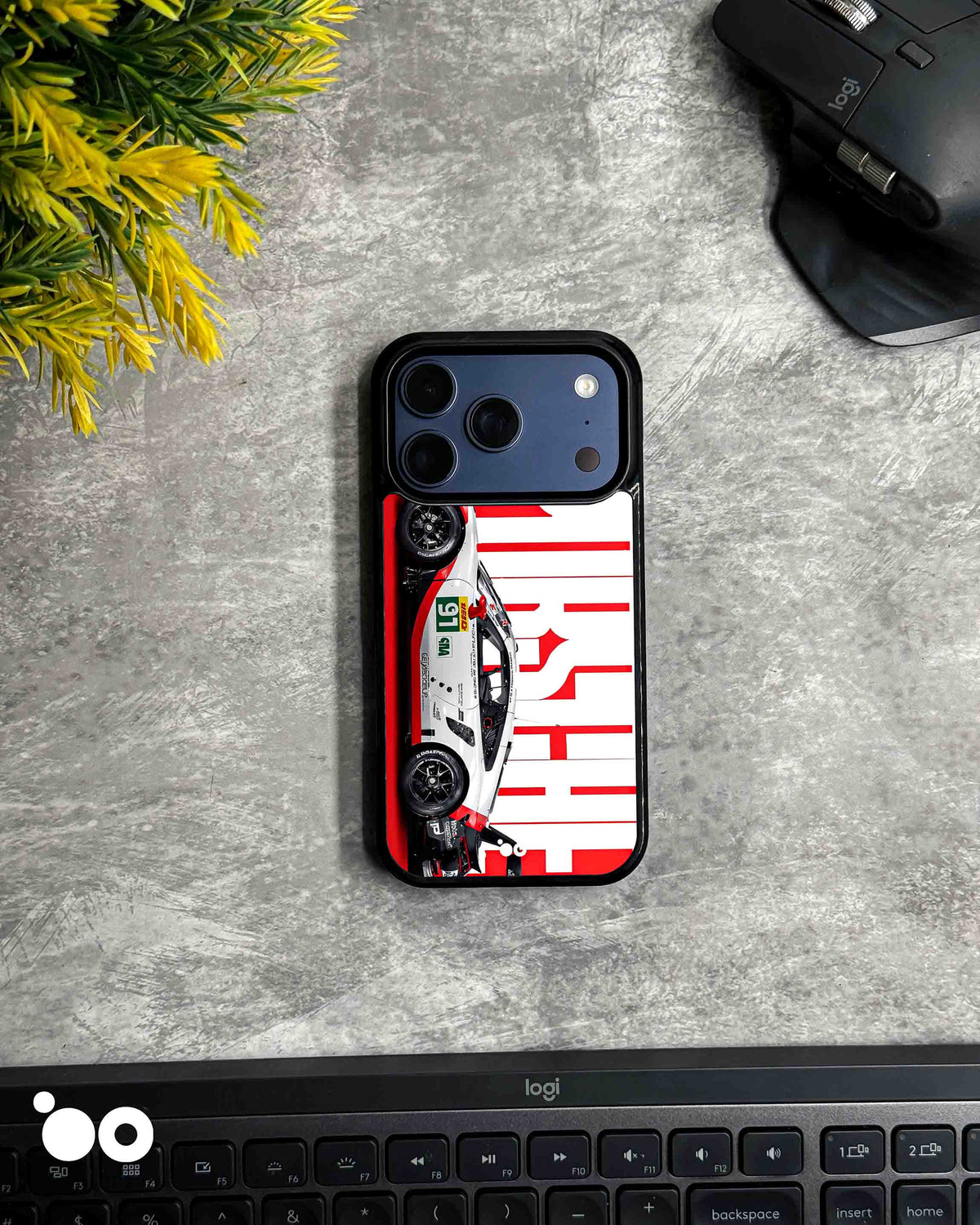 Porsche Racing Heritage iPhone case featuring a white Porsche race car with red and black detailing, bold oversized Porsche typography and a striking red and white motorsport background.